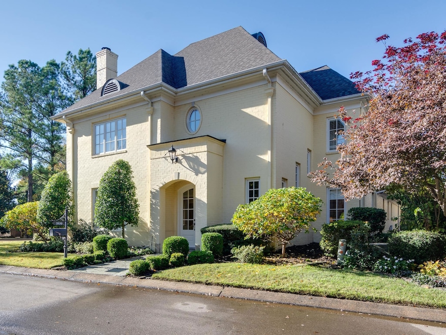 View of front of house featuring roof with shingles, a chimney, and brick siding