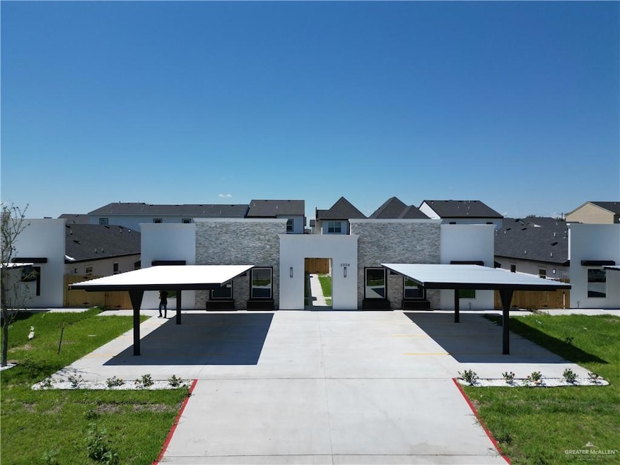 Modern home with stone siding, a residential view, and stucco siding