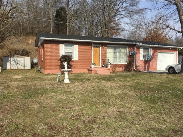 Brick home with concrete drive and garage