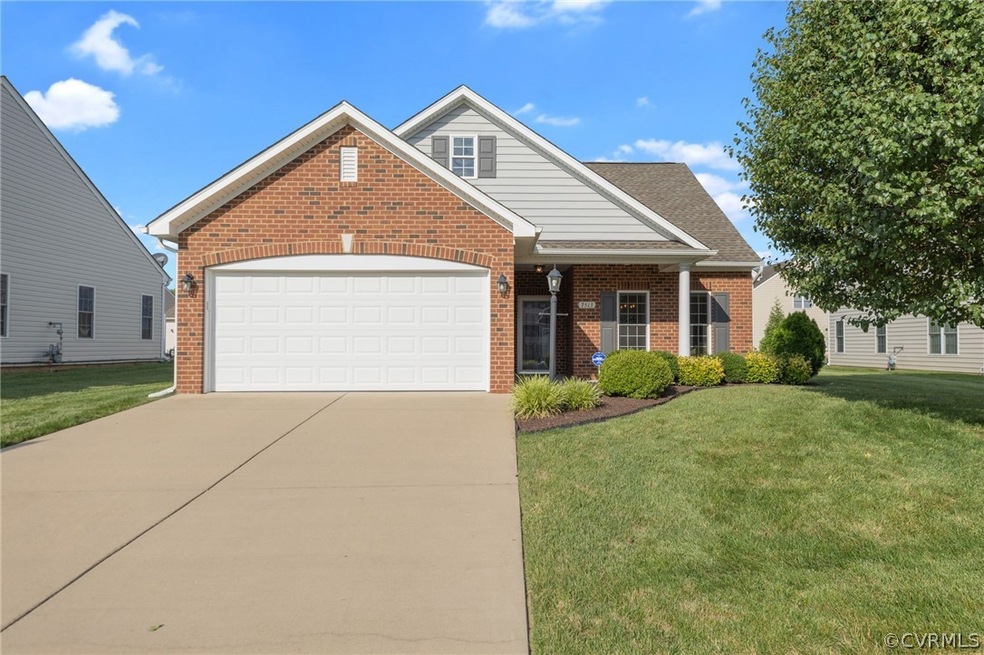 View of front of home with a front lawn and a gara