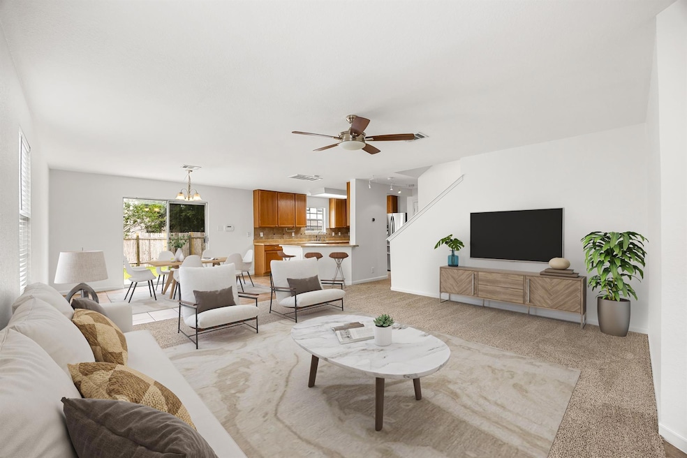 Living area featuring light colored carpet, a cei