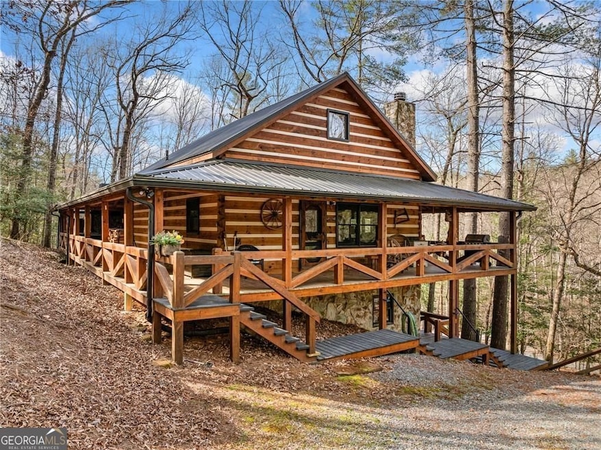 Wrap around porch brings you to the hot tub and cover patio featuring a stone wood burning fireplace