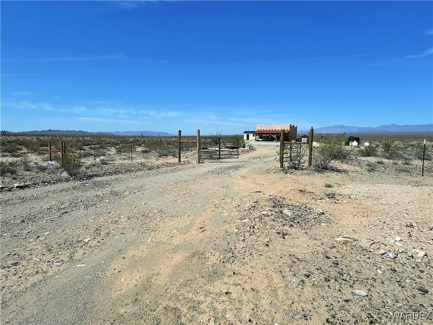 View of yard with a rural view and a mountain view