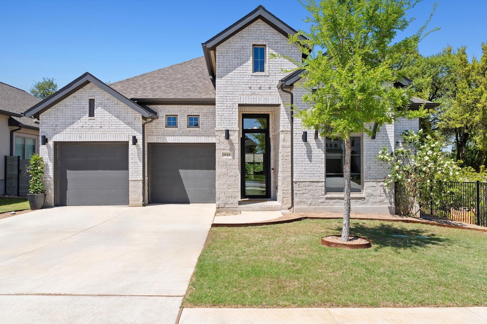 View of front of home with a front yard, fence, s