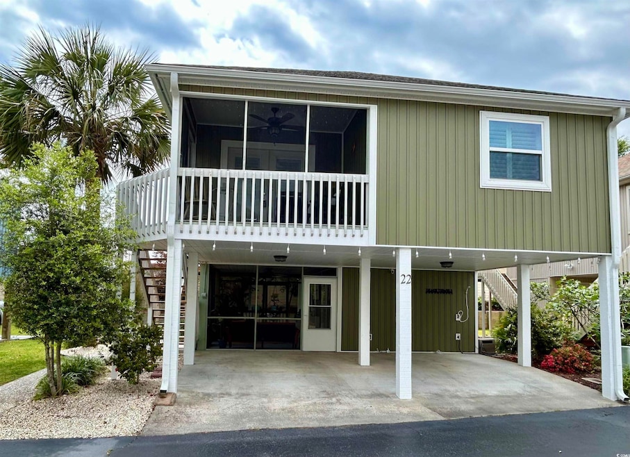 Beach home featuring a sunroom, a carport, stairs,
