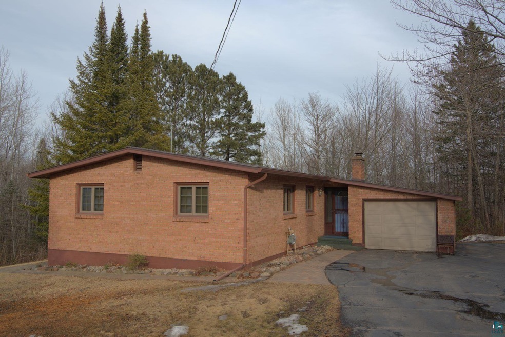 View of front facade featuring a chimney, an attac