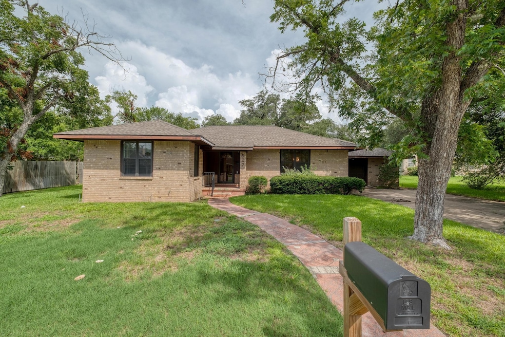 Single story home featuring brick siding and roof