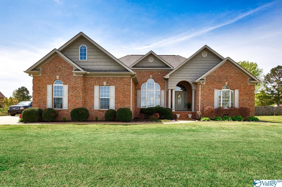 Full brick home featuring concrete drive and sidew