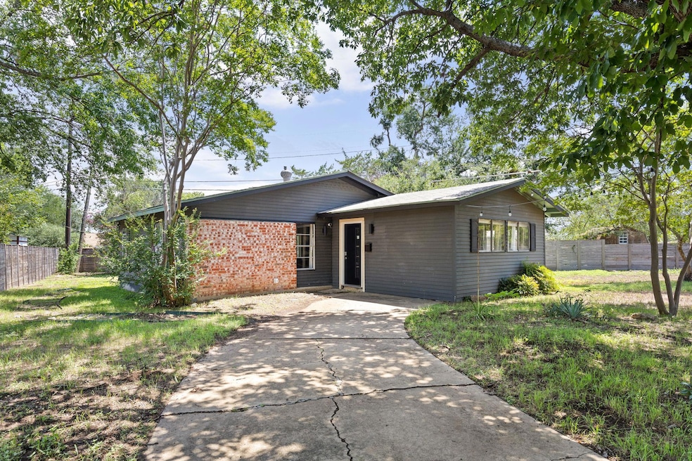 Ranch-style home featuring concrete driveway and 