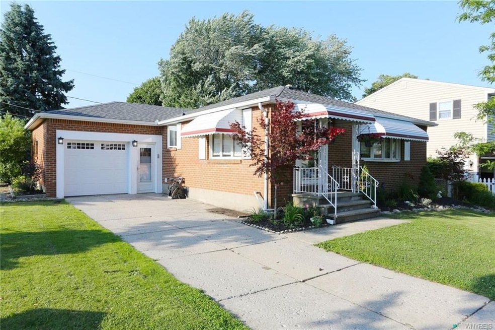 All brick ranch with newer garage door on corner l