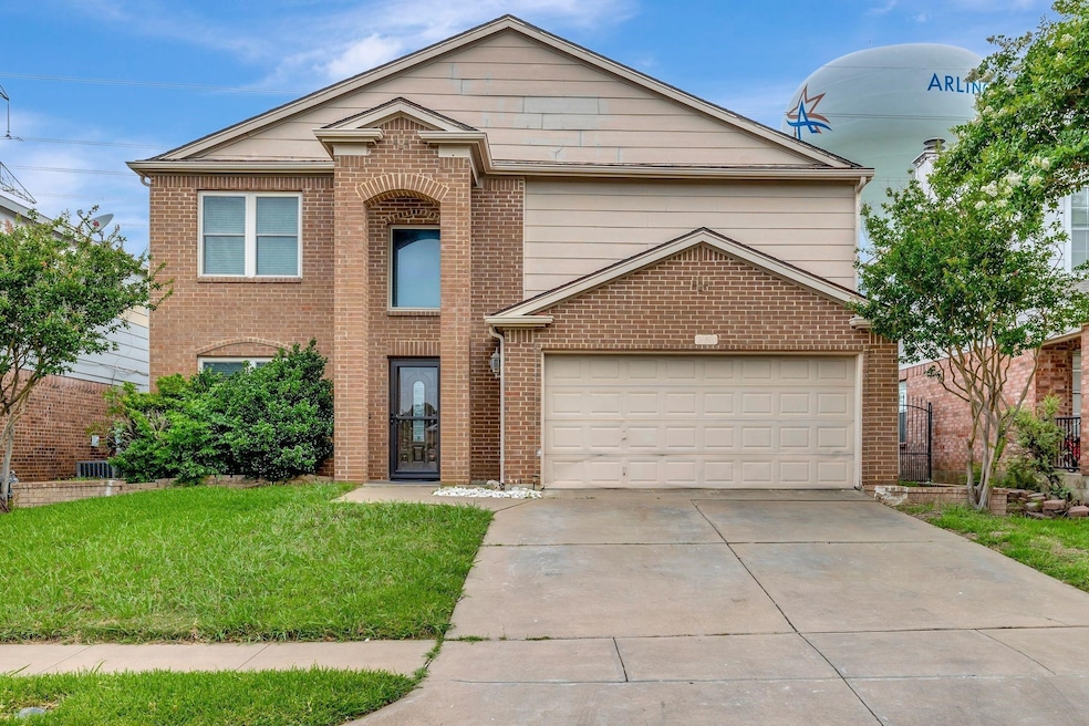 Traditional home featuring brick siding, concrete driveway, and a garage