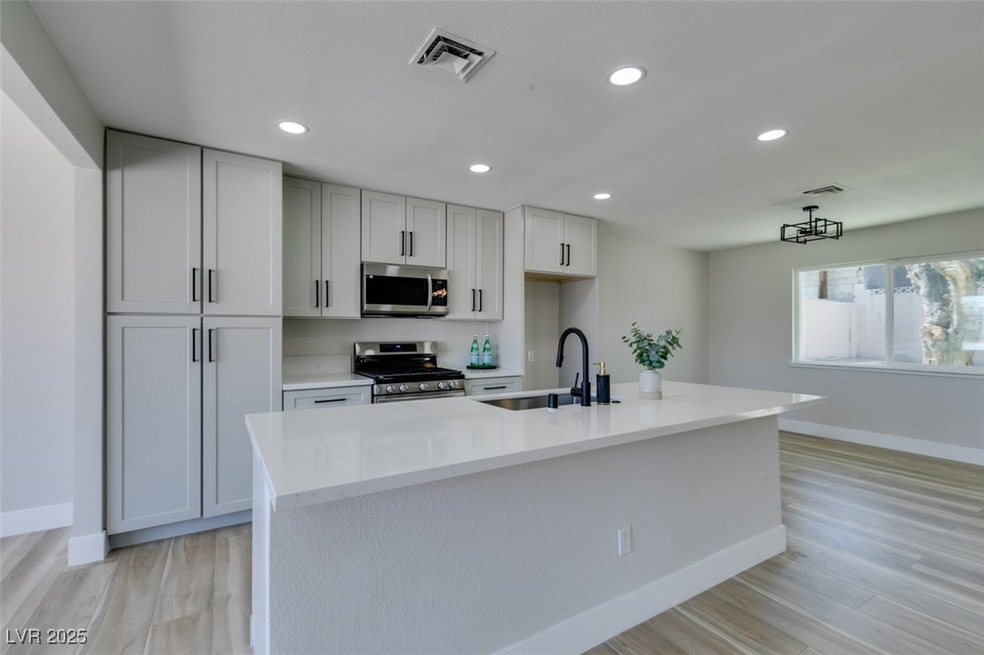 Kitchen featuring light wood finished floors, base