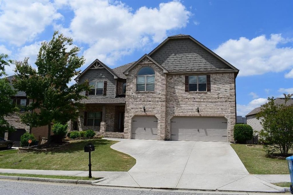 View of front facade with a front yard and a garag