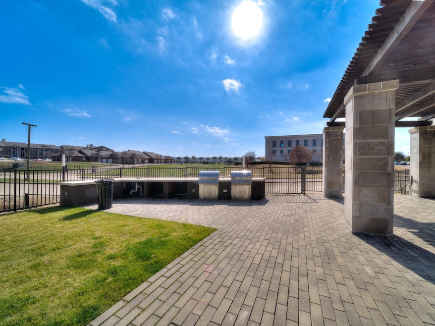 View of patio with fence, area for grilling, and a