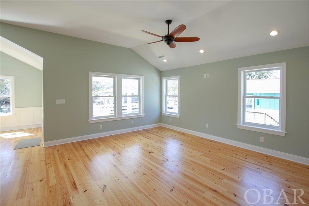 light pine hardwoods throughout living room, kitch