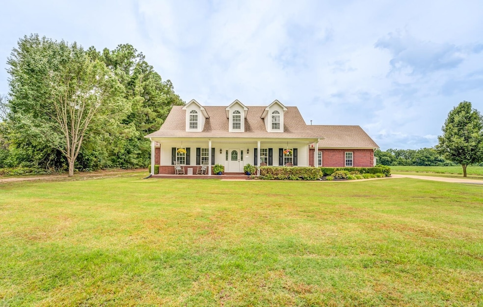 Cape cod-style house featuring a porch and a front