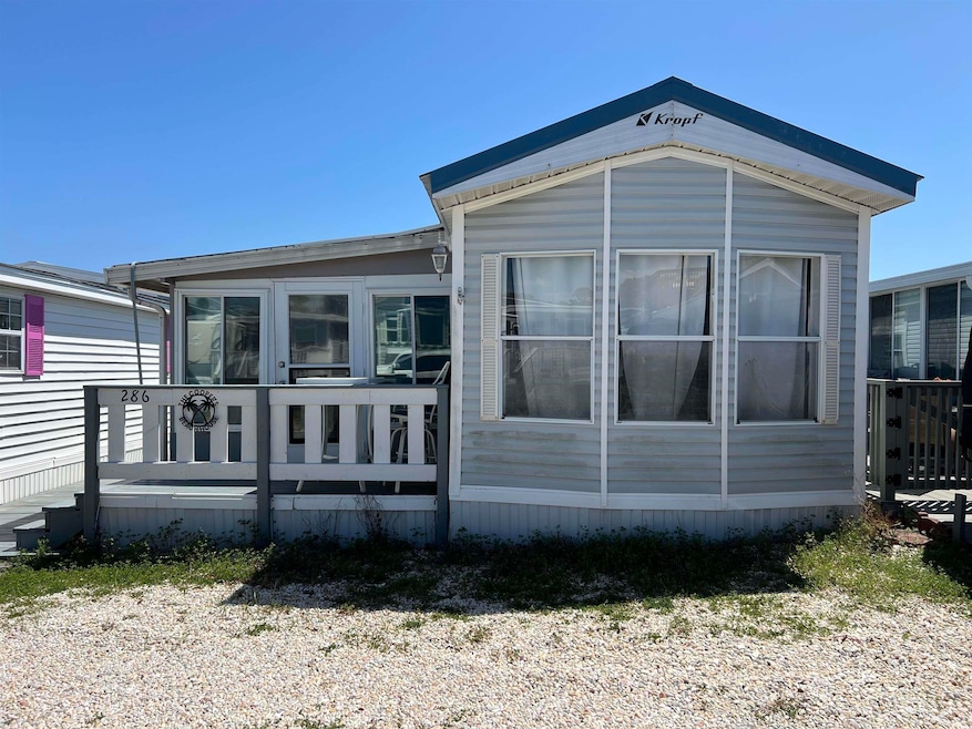 View of side of property with a sunroom