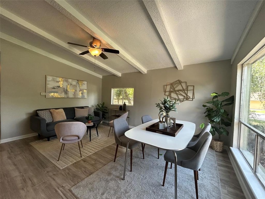Dining room featuring a textured ceiling, wood fi