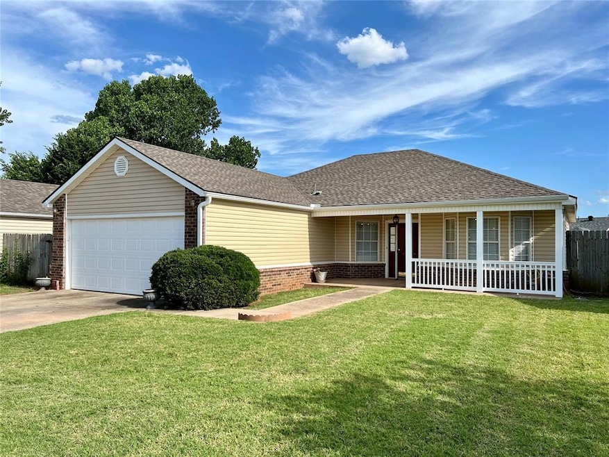 Ranch-style home with a porch, a garage, and a fro