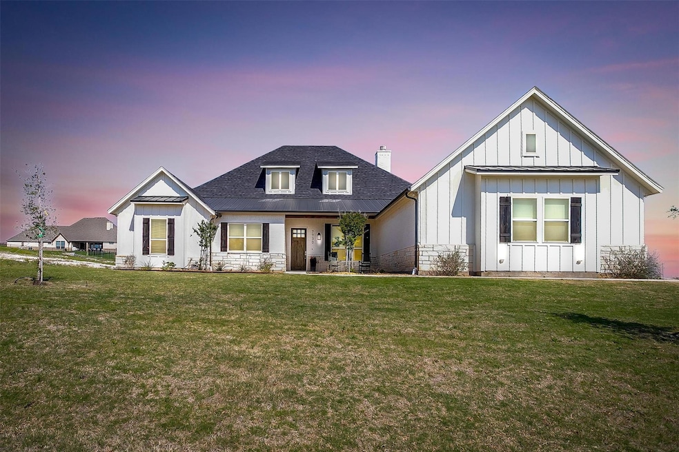 Modern inspired farmhouse with roof with shingles,