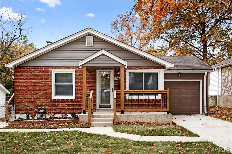 View of front of home with brick siding, concrete driveway, an attached garage, and a front lawn