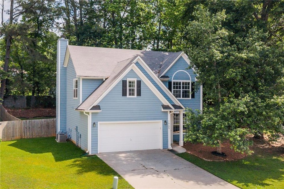 Traditional home featuring driveway, a chimney, an