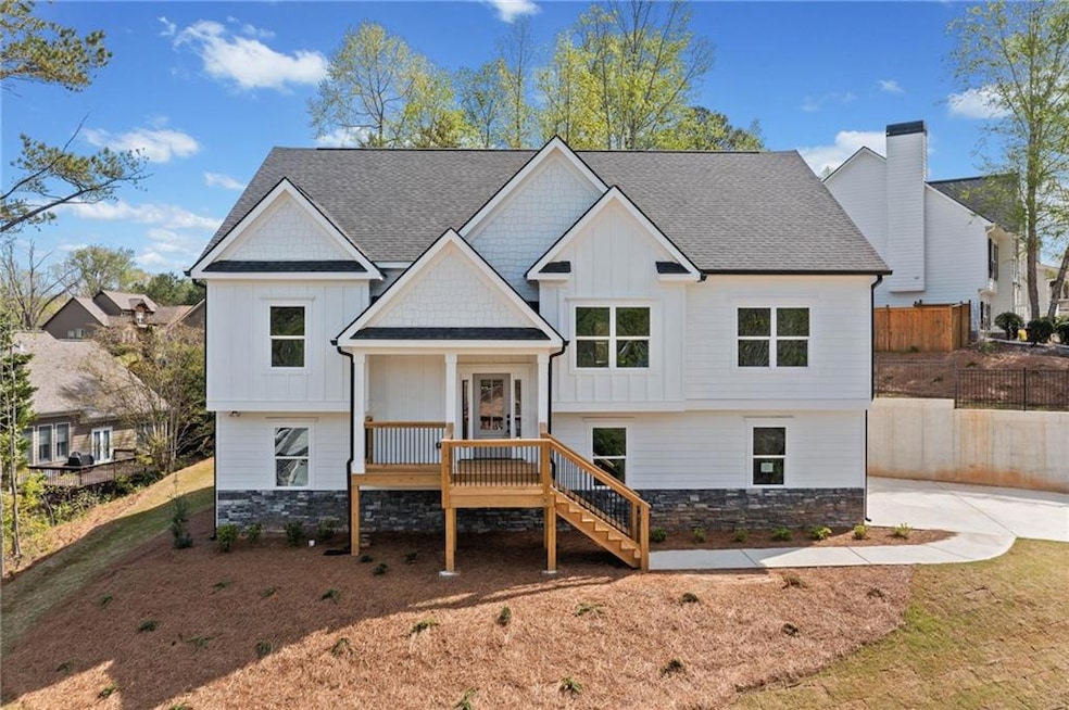 View of front of house featuring stairway, a deck,