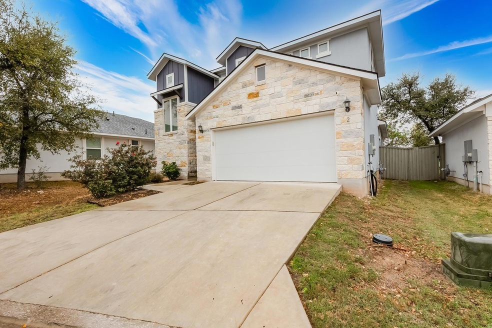 View of front of property featuring fence, stone 