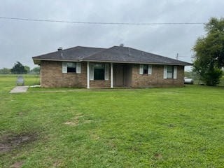 Back of property featuring a yard