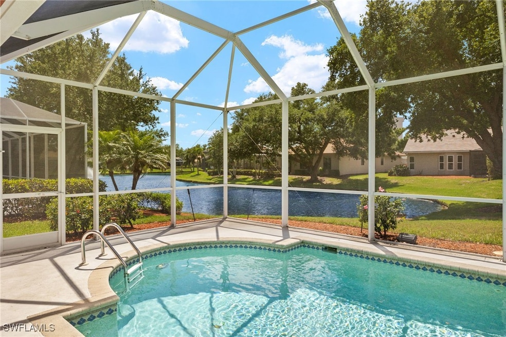 Outdoor pool with a water view, a patio, a lawn, a