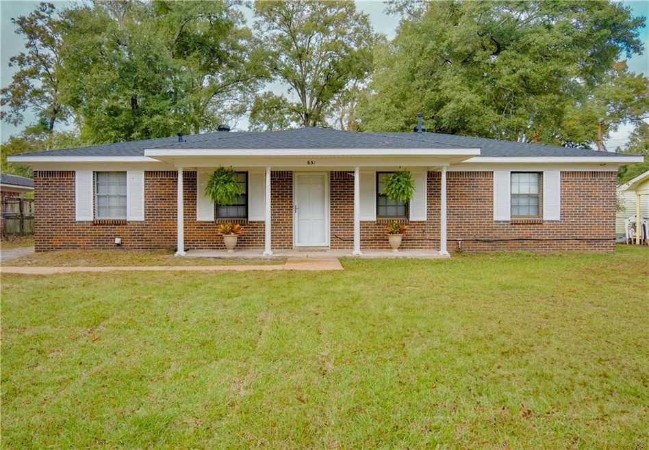 Ranch-style home featuring a front yard