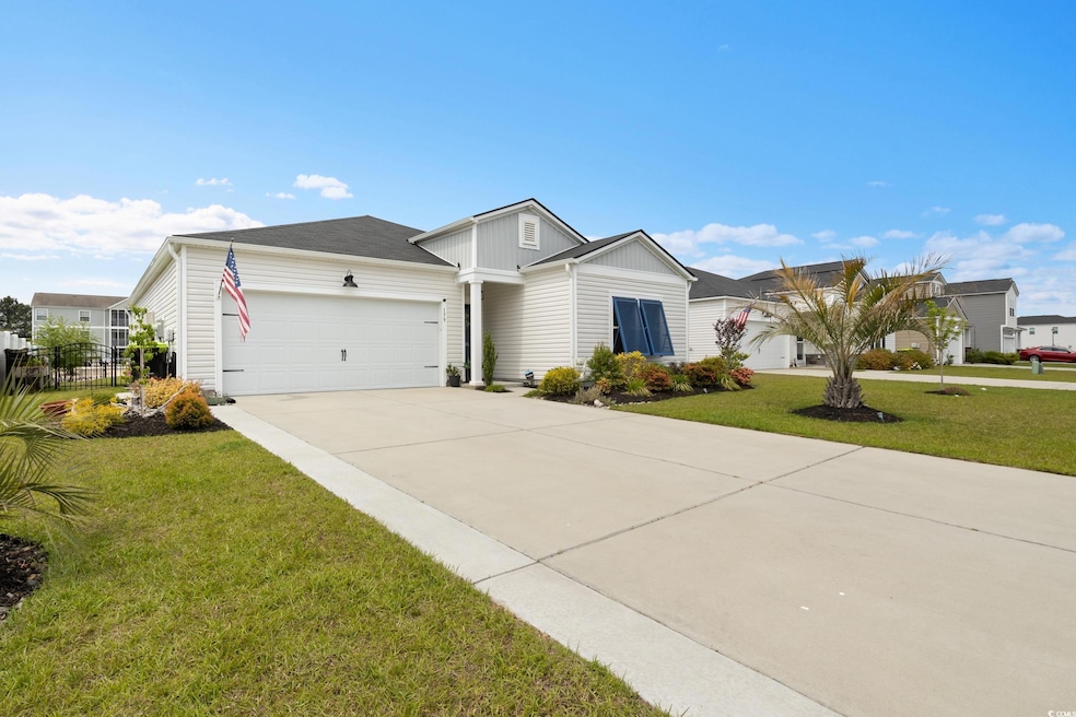 Ranch-style home with concrete driveway, fence, an