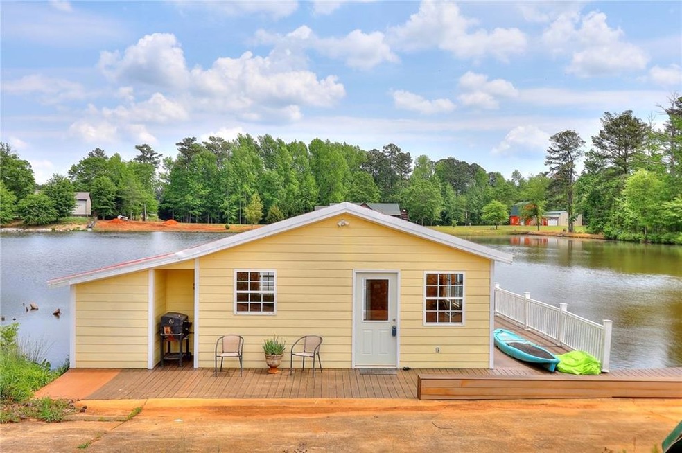 View of front of house with a deck with water view