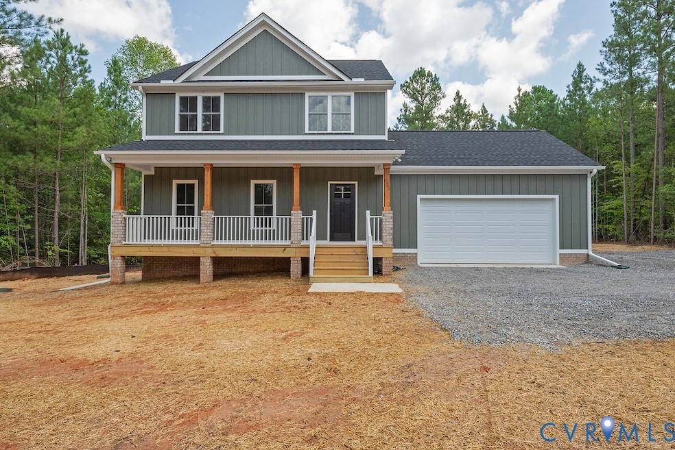 View of front facade featuring a porch, gravel driveway, roof with shingles, board and batten siding, and an attached garage