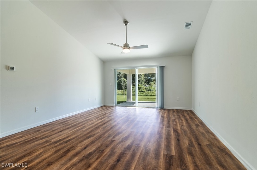 Spare room featuring baseboards, ceiling fan, visi