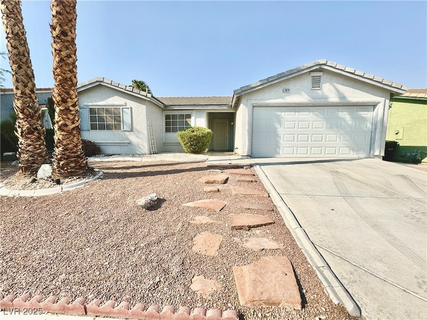 Ranch-style home with concrete driveway, an attach