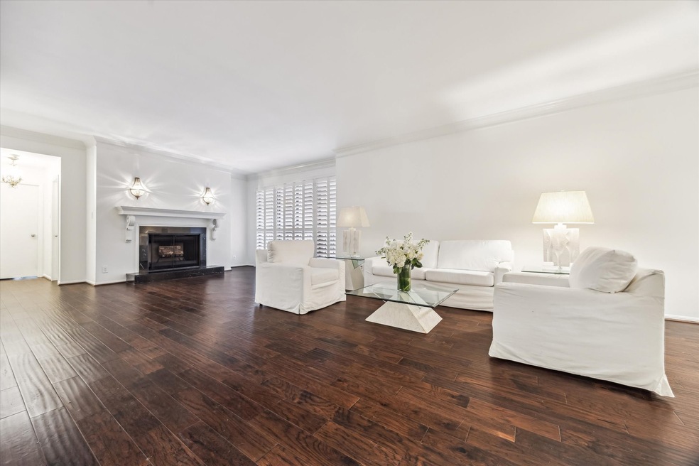 This spacious living room features elegant dark wo
