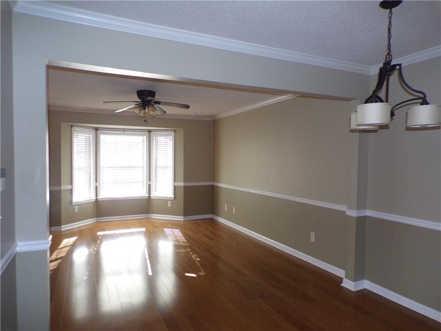 Large open living/ dining room with hardwood floor