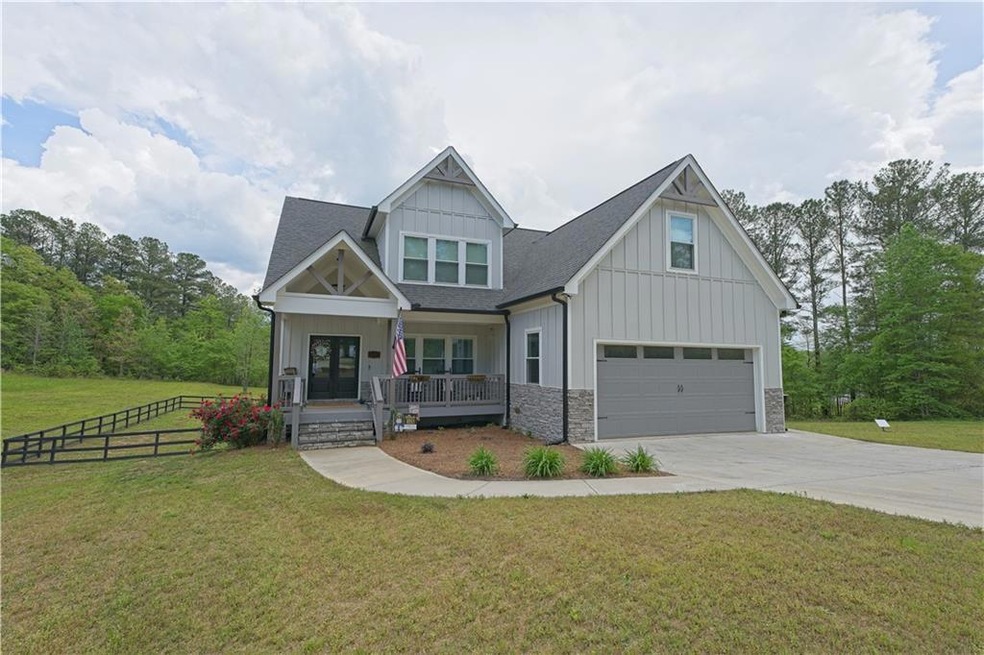 Craftsman inspired home featuring fence, concrete 