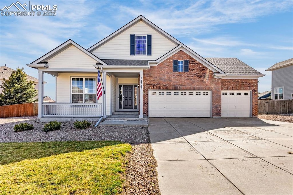 Traditional-style house with a garage, fence, conc