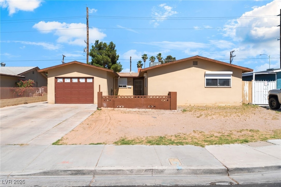 Ranch-style house featuring stucco siding, an atta