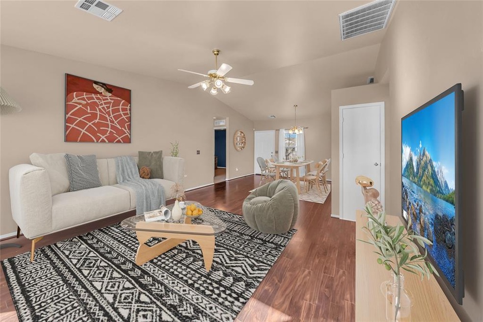 Living room featuring lofted ceiling, ceiling fan,