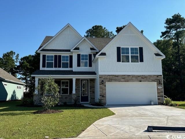 Craftsman-style home with a garage and a front law
