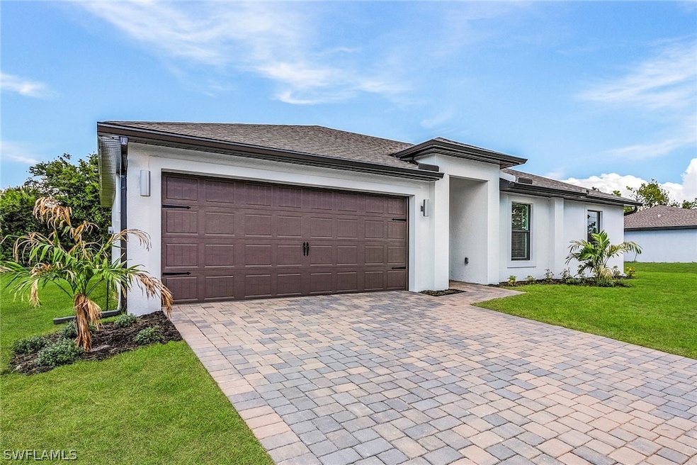 View of front of property with a garage and a fron