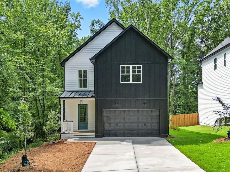Modern inspired farmhouse with a standing seam roof, an attached garage, a metal roof, concrete driveway, and board and batten siding