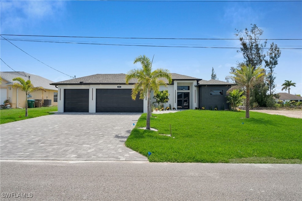 Ranch-style house with decorative driveway, a fron