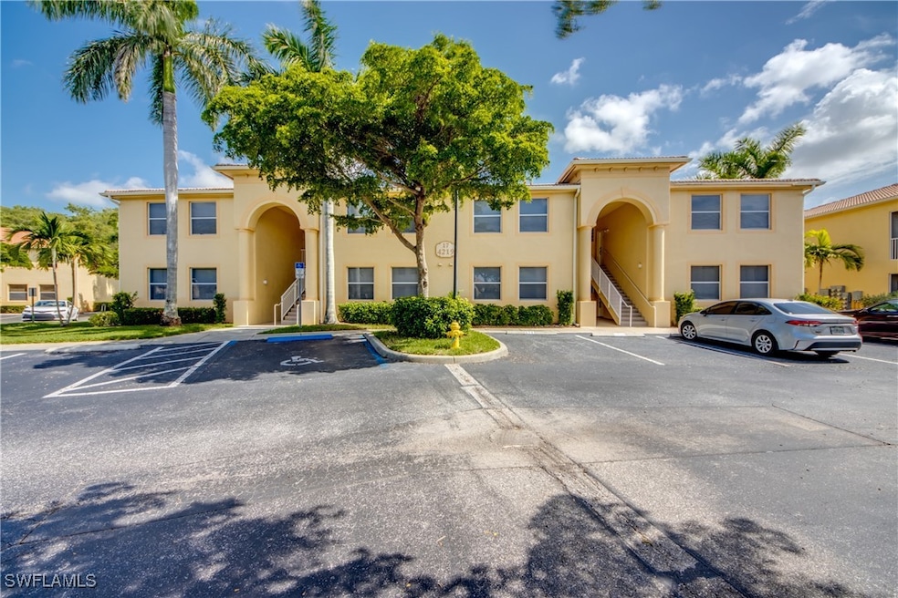 View of property featuring uncovered parking