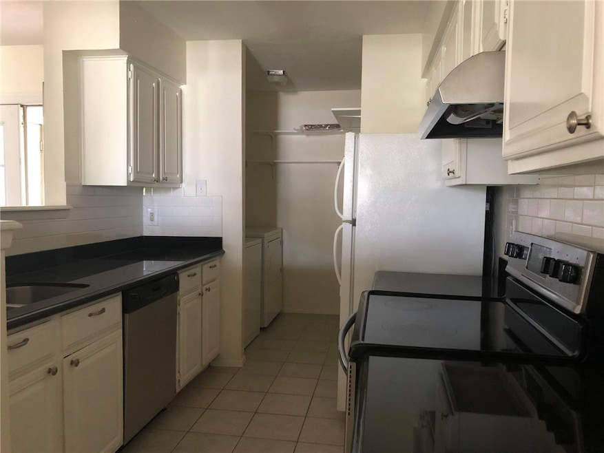 Kitchen featuring washing machine and dryer, light