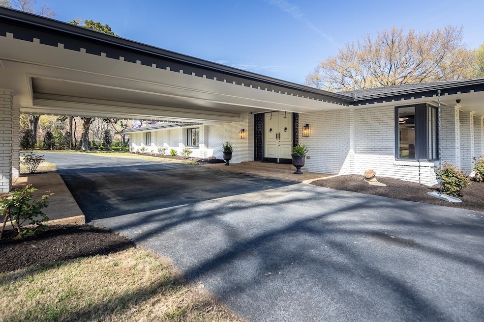 View of front of house with brick siding and asphalt driveway