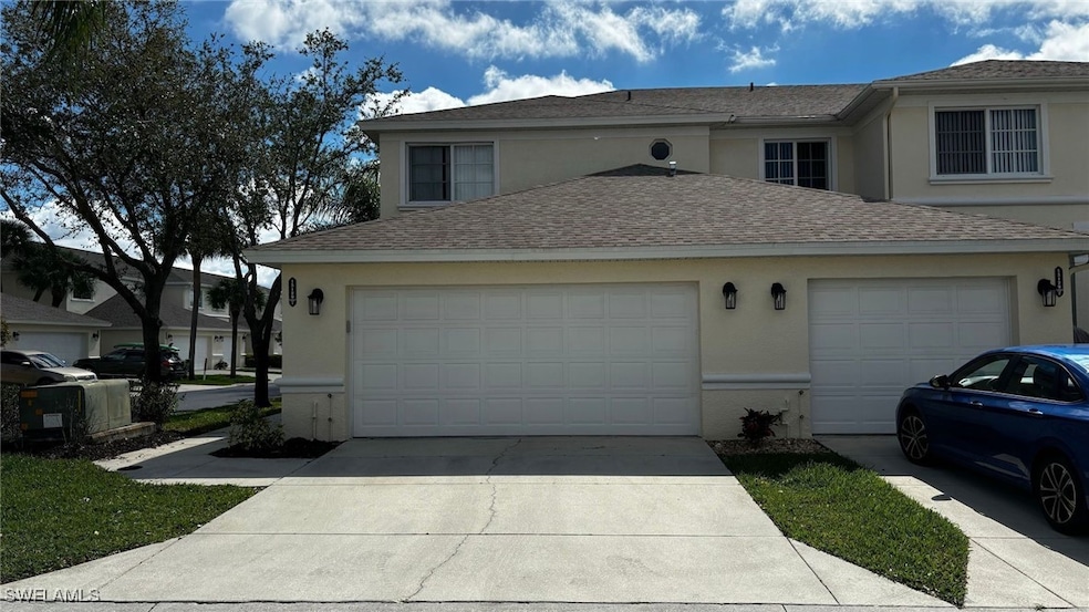 View of side of property featuring concrete drivew